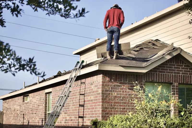 Professional roofer working on a residential roof in Upper Macopin